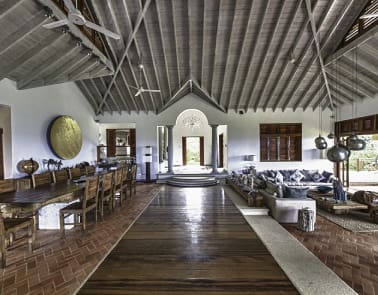 A large room with wooden floors and vaulted ceilings.