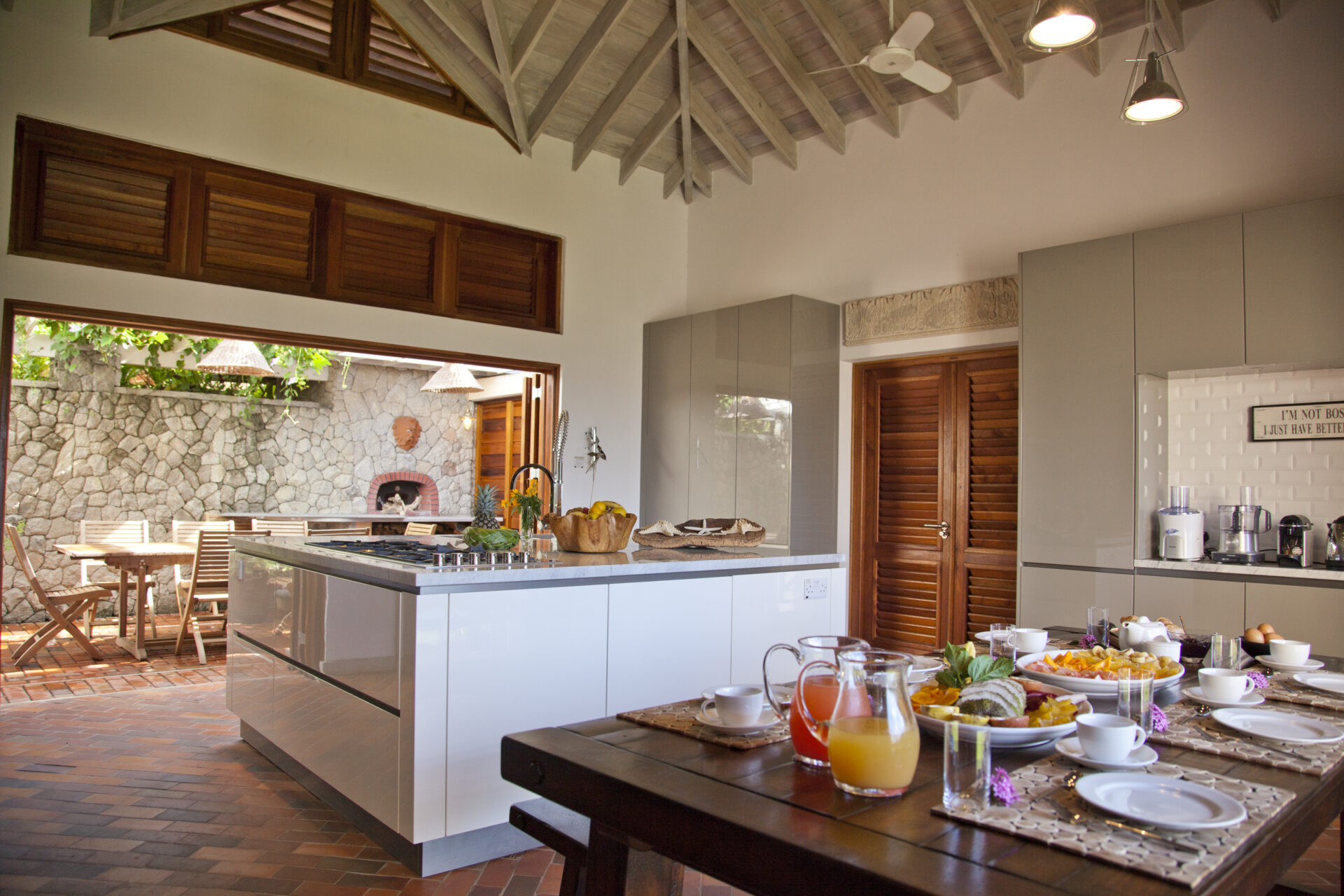 A kitchen with a table and chairs, and a large island.