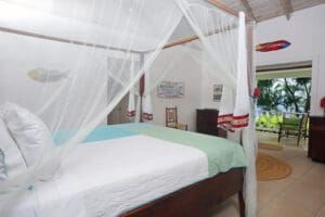 A bed room with a four poster bed and white canopy