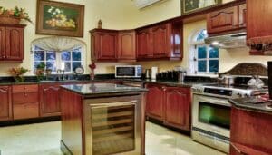 A kitchen with wooden cabinets and granite counter tops.